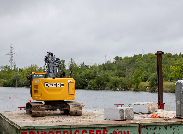 Yellow digger on a barge on the Otonabee River