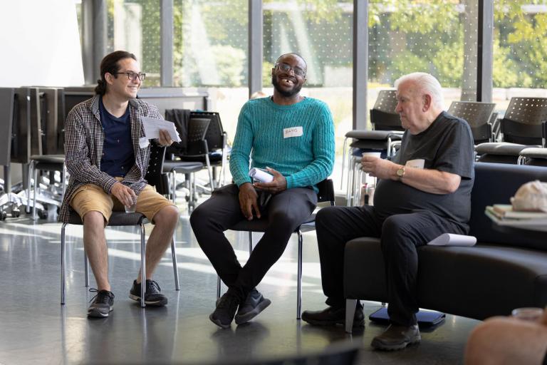 Photo of three people at Seniors Village event talking